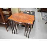 A nest of three continental style tables having brass elephant head decoration to legs with