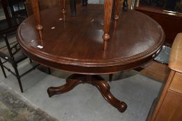 A Victorian mahogany snap top dining table on turned column and triple splay legs