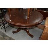 A Victorian mahogany snap top dining table on turned column and triple splay legs