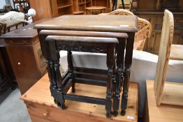 A mid to late 20th Century traditional oak nest of three tables