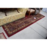 A large carpet square having vibrant green and red ground approx 320cm x 280cm good condition one