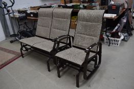 A Pagoda garden gliding rocking seat and similar rocking two seat settee both with light use