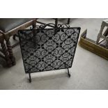 A wrought iron and wirework fire guard/screen