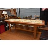 A mid century tile top table having under rack, approx. 116 x 42cm