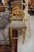 A pair of high seated stools having wooden frames 65cm high to seat, bit grubby but sound