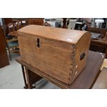 An antique pine chest having curved plank top and dovetail sides 68cm wide 39cm deep