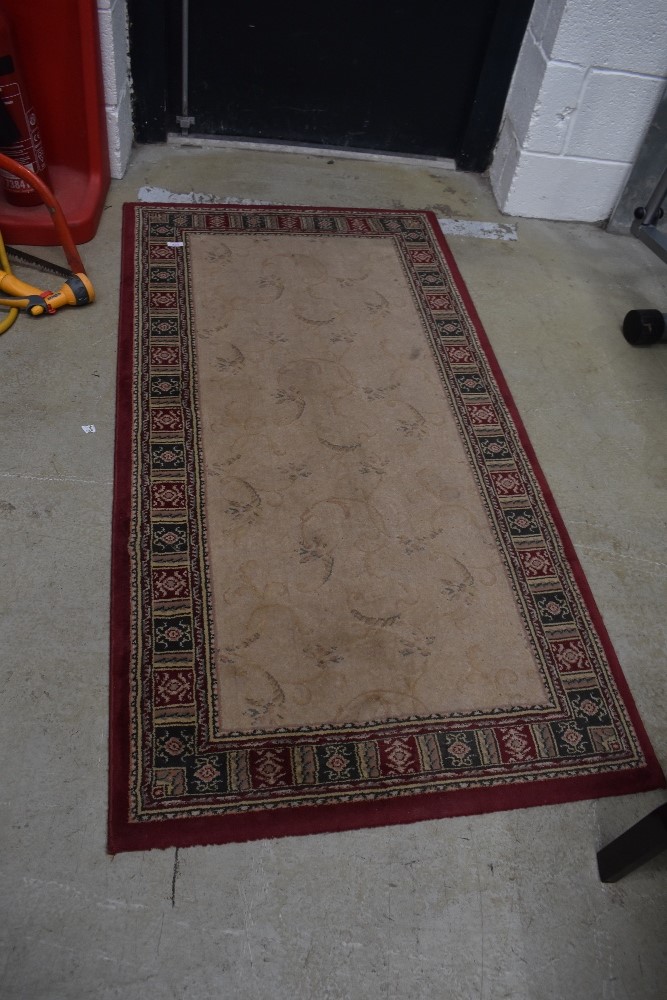 A vintage wool rug or hall way carpet 150cm long by 80cm wide