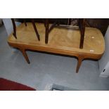 A mid century oak coffee table having quarter panel top