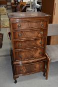 A reproduction flame mahogany chest of five narrow drawers, on cabriole legs, width approx. 52cm,