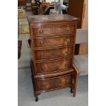 A reproduction flame mahogany chest of five narrow drawers, on cabriole legs, width approx. 52cm,