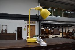 A metal bodied yellow bedside or desk lamp