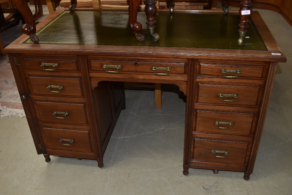 A late Victorian mahogany desk in the Aesthetic style, later skiver leather top and mounted on