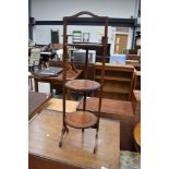 An antique three tier folding cake stand in oak