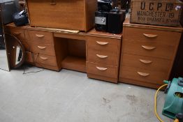 A set of laminate bedroom furniture including desk two sets of three drawers and one set of four