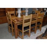 A top quality modern solid golden oak dining table and set of eight matching ladderback chairs,