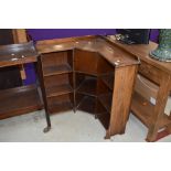 An early 20th Century oak corner bookshelf of small proportions, having integral smokers cabinet,