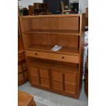 A vintage Nathan bookshelf, with central drawer section and double cupboards to base, dimensions
