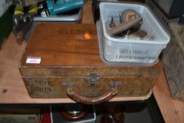 An electric drill in wooden case