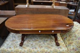 A hard wood reproduction coffee table having carved leg and frame work, dimensions approx. W89,