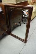 A modern mahogany effect wall mirror, approx. 85 x 61cm