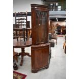 A modern reproduction regency corner display, with cupboard under