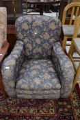 A nice quality early 20th Century low seat armchair having blue foliate upholstery