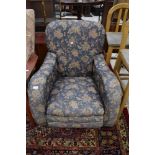 A nice quality early 20th Century low seat armchair having blue foliate upholstery