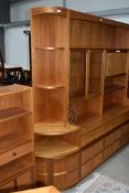 A vintage Nathan corner shelf with cupboard under