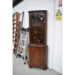 A reproduction Regency style corner display having cupboard under