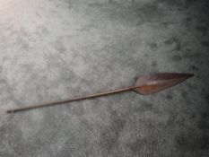 An antique possible Polynesian ceremonial paddle having pointed handle and carved curved paddle,