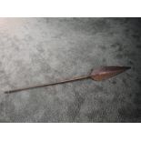 An antique possible Polynesian ceremonial paddle having pointed handle and carved curved paddle,