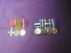 A group of three miniature medals The Order of the British Empire Medal Defence Medal and War