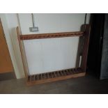A pine free standing upright Gun Rack, spaces for 17 guns, width 142cm, height 122cm