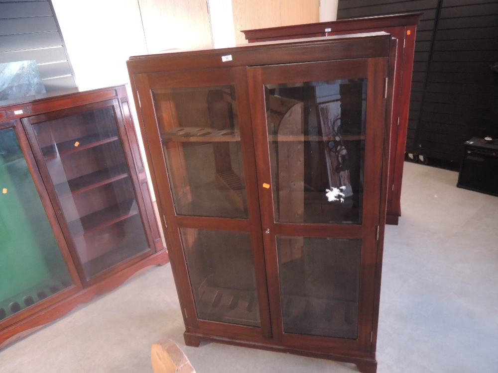 A mahogany and glazed free standing upright Gun Cabinet, spaces for 8 guns, width 96cm, height