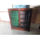 A mahogany and glazed free standing upright Gun Case, spaces for 7 guns and four shelves width