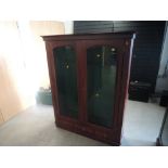 A mahogany and glazed free standing upright Gun Cabinet, spaces for 9 guns and three drawers