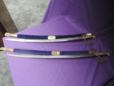 A pair of Indian Hangers/Swords having brass handles and guards, decoration faded to blades, with