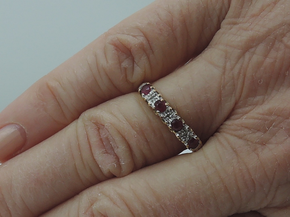 A lady's half eternity ring having four rubies interspersed by diamond chips on a 9ct gold loop, - Image 2 of 2