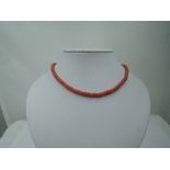 A string of coral beads of cylindrical form, no clasp, approx 22'