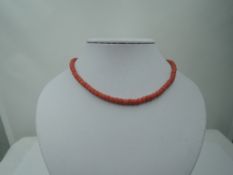 A string of coral beads of cylindrical form, no clasp, approx 22'