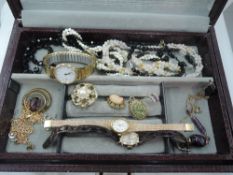 A Swedish jewellery box containing a selection of costume jewellery including wrist watches, fashion