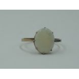 A lady's dress ring having an oval opal in a claw set mount on a rose gold loop tested as 9ct