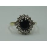 A lady's dress ring having a sapphire and diamond oval cluster having brilliant cut and baguette cut
