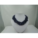 A woven multi strand rough cut lapis lazuli necklace of collarette style