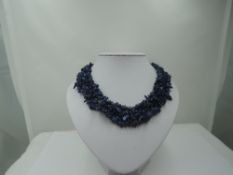 A woven multi strand rough cut lapis lazuli necklace of collarette style