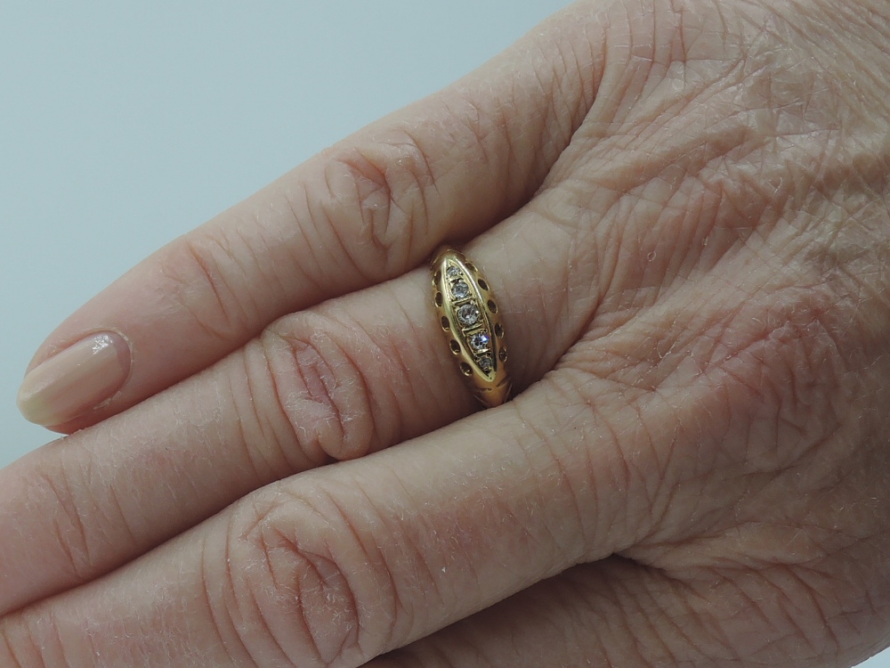 A lady's dress ring having five graduated diamond chips in a gallery mount on an 18ct gold loop, - Image 2 of 2