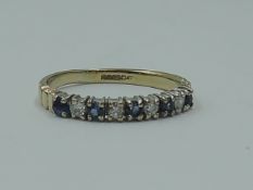 A lady's half eternity ring having five sapphires interspersed by diamond chips in a 9ct gold