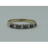 A lady's half eternity ring having five sapphires interspersed by diamond chips in a 9ct gold