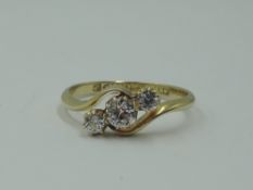 A lady's dress ring having a trio of clear stones, possibly white sapphires, in a claw set mount