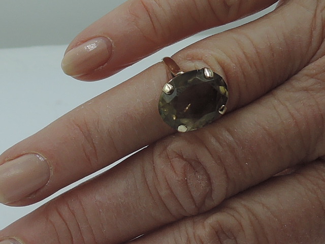 A lady's dress ring having an oversized yellow/brown oval stone in a four claw basket mount on a 9ct - Image 2 of 2